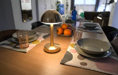 a table with a lamp and plates and glasses on a table at Espectacular Loft Piscina y Terraza - Roig Arena - Las Ciencias - Ruzafa - Valencia Centro in Valencia