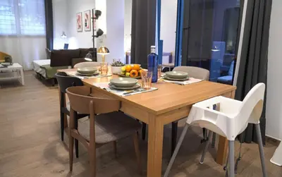 a dining room with a wooden table and chairs at Espectacular Loft Piscina y Terraza - Roig Arena - Las Ciencias - Ruzafa - Valencia Centro in Valencia