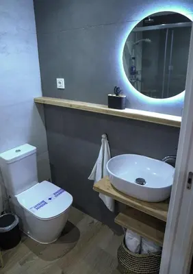 a bathroom with a sink and a toilet and a mirror at Espectacular Loft Piscina y Terraza - Roig Arena - Las Ciencias - Ruzafa - Valencia Centro in Valencia