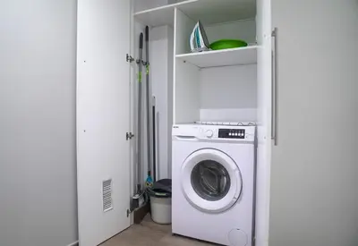 a washer and dryer in a white laundry room at Espectacular Loft Piscina y Terraza - Roig Arena - Las Ciencias - Ruzafa - Valencia Centro in Valencia