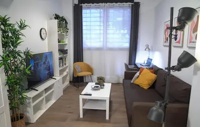 a living room with a couch and a tv at Espectacular Loft Piscina y Terraza - Roig Arena - Las Ciencias - Ruzafa - Valencia Centro in Valencia