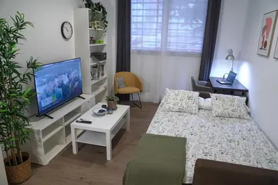 a small room with a bed and a tv at Espectacular Loft Piscina y Terraza - Roig Arena - Las Ciencias - Ruzafa - Valencia Centro in Valencia