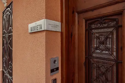 a sign on the side of a building next to a door at La Novieta Boutique Hotel - Adults Only in Valencia