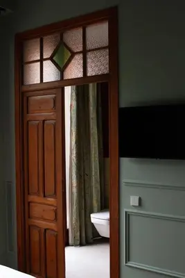 a door to a bathroom with a toilet and a window at La Novieta Boutique Hotel - Adults Only in Valencia