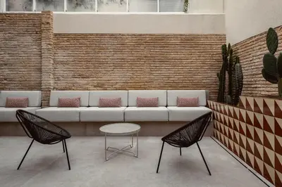 a living room with a couch and two chairs and a table at La Novieta Boutique Hotel - Adults Only in Valencia