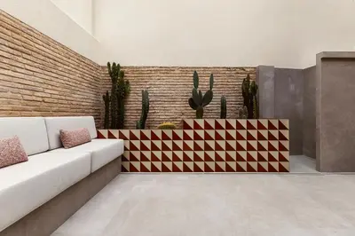 a living room with a couch and cactus at La Novieta Boutique Hotel - Adults Only in Valencia