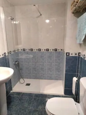 a bathroom with a shower with a toilet and a sink at Duplex en Navajas (Castellón) in Navajas
