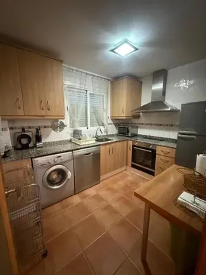 a bathroom with two sinks and a toilet and a shower at Duplex en Navajas (Castellón) in Navajas