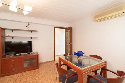 a living room with a glass table and a television at Global Vacacional, Apartamento céntrico en Puerto de Sagunto para 5 personas in Puerto de Sagunto