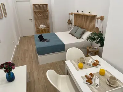 a small room with a bed and a table with food on it at Travel Habitat Cabanyal Lofts in Valencia