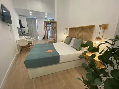 a bedroom with a bed and a living room at Travel Habitat Cabanyal Lofts in Valencia