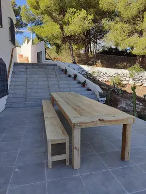 a wooden picnic table and bench on a patio at Fully private villa for 12p with large pool in Valencia-Náquera in Náquera