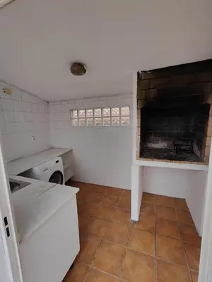 a kitchen with a fireplace in a white kitchen at Fully private villa for 12p with large pool in Valencia-Náquera in Náquera