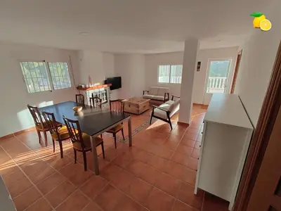 a living room with a dining room table and chairs at Fully private villa for 12p with large pool in Valencia-Náquera in Náquera