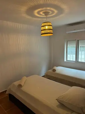 a bedroom with two beds and a chandelier at Fully private villa for 12p with large pool in Valencia-Náquera in Náquera