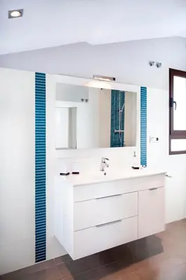 a white bathroom with a sink and a mirror at Torres de Serranos Apartments - TTdSSa VLC in Valencia