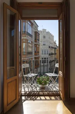 an open door leading to a balcony with chairs at Torres de Serranos Apartments - TTdSSa VLC in Valencia