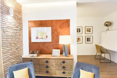 a room with two chairs and a dresser with a lamp at Torres de Serranos Apartments - TTdSSa VLC in Valencia