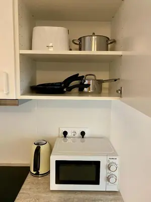 a kitchen with a microwave and a pot on a shelf at RIZADA RUZAFA in Valencia