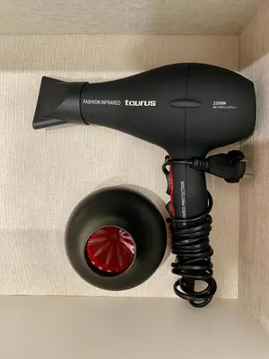 a hair dryer is hanging on a wall at RIZADA RUZAFA in Valencia