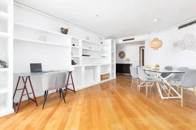 a dining room with white walls and a table and chairs at Travel Hábitat L'Umbracle in Valencia