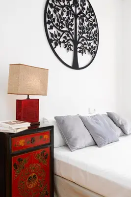 a bedroom with a bed and a table with a lamp at Travel Hábitat L'Umbracle in Valencia