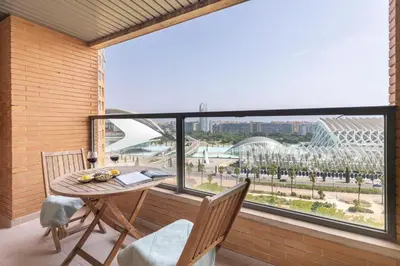 a balcony with a table and chairs and a large window at Travel Hábitat L'Umbracle in Valencia