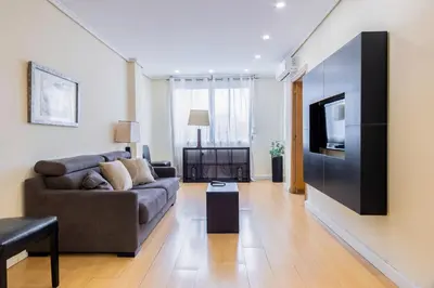 a living room with a couch and a television at Alcam Arte Ciencia in Valencia