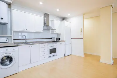 a kitchen and a living room with a couch at Alcam Arte Ciencia in Valencia