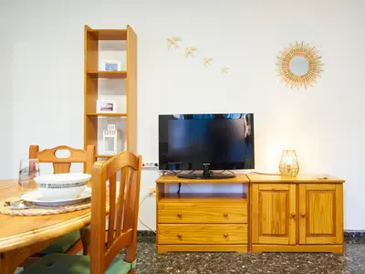 a television sitting on top of a wooden dresser at EL RINCÓN VERDE in Puerto de Sagunto