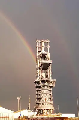 a rainbow in the sky behind a building at EL RINCÓN VERDE in Puerto de Sagunto