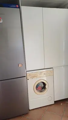 a washing machine and a washer in a kitchen at Adosado/casa con terraza y buhardilla. Playa El Perelló in El Perelló