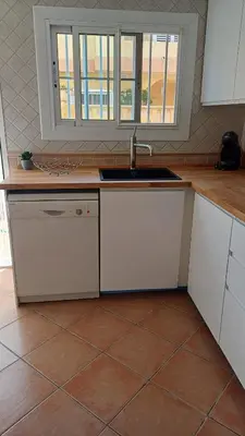 a kitchen with a sink and a counter top at Adosado/casa con terraza y buhardilla. Playa El Perelló in El Perelló