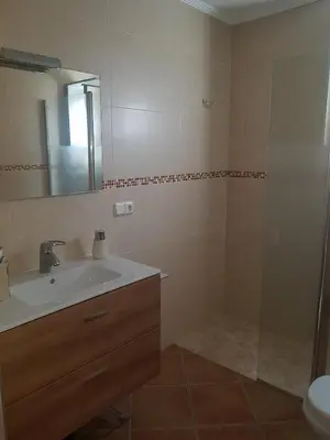 a bathroom with a sink and a mirror at Adosado/casa con terraza y buhardilla. Playa El Perelló in El Perelló