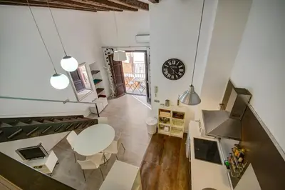 a living room with a staircase and a table and chairs at Apartamento REPESO in Valencia