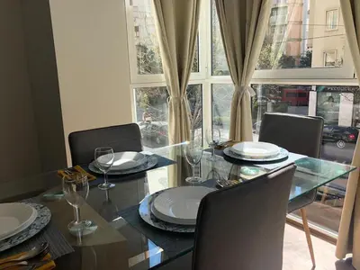 a dining room with a glass table and chairs at centrico cerca al ayuntamiento+luminoso+acogedor in Valencia