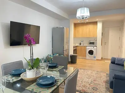 a living room with a dining table and a kitchen at centrico cerca al ayuntamiento+luminoso+acogedor in Valencia