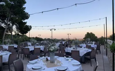 a dining room with white tables and chairs at Vista Golf in Valencia