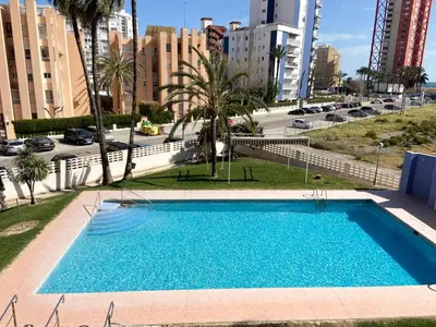a swimming pool in the middle of a city with buildings at Apt. En la Playa, Wifi rápido y piscina. in Puebla de Farnals
