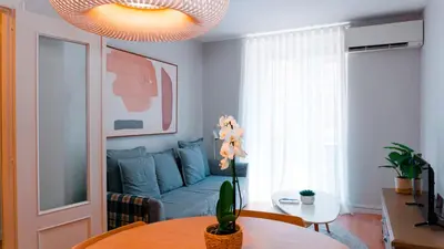 a living room with a blue couch and a table at Cervantes Prime in Valencia