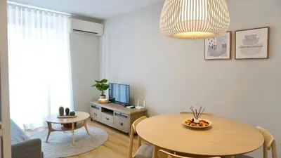 a living room with a wooden table and a dining room at Cervantes Prime in Valencia