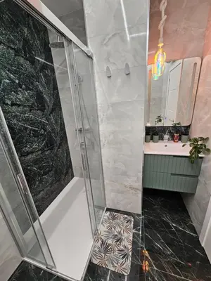 a bathroom with a shower and a sink and a mirror at Lounge garden sea mint fresh in Valencia