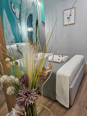 a bedroom with a bed and a vase with flowers at Lounge garden sea mint fresh in Valencia