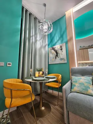 a living room with a table and a couch at Lounge garden sea mint fresh in Valencia