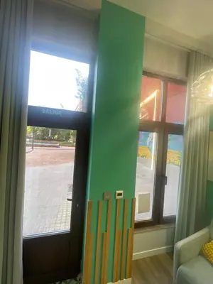 a room with a door with windows and a couch at Lounge garden sea mint fresh in Valencia