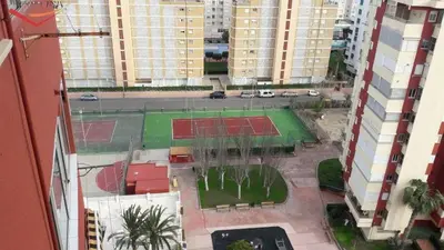 an aerial view of a tennis court in a city at Amplio apartamento in Puebla de Farnals