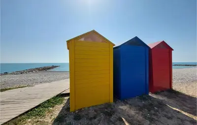 a row of colorful beach huts on the beach at 2 Bedroom Nice Apartment In Moncofa in Moncófar