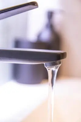 a stream of water coming out of a faucet at Favara Flats by Concept in Valencia