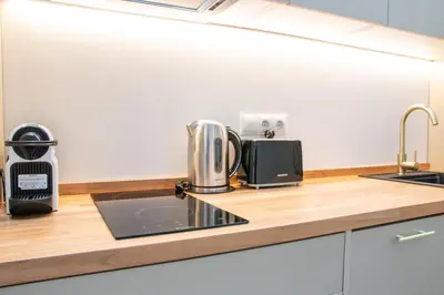 a kitchen counter with a coffee maker and a sink at Favara Flats by Concept in Valencia