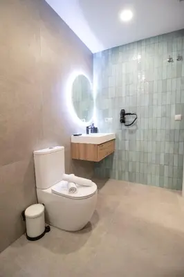 a bathroom with a toilet and a sink and a mirror at Favara Flats by Concept in Valencia